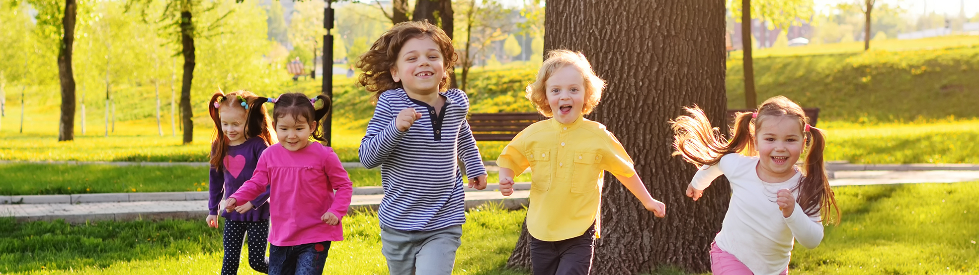 Group of kids running outdoors after seeing their dentist for children