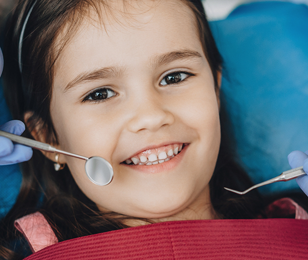 Young girl smiling during a dental checkup